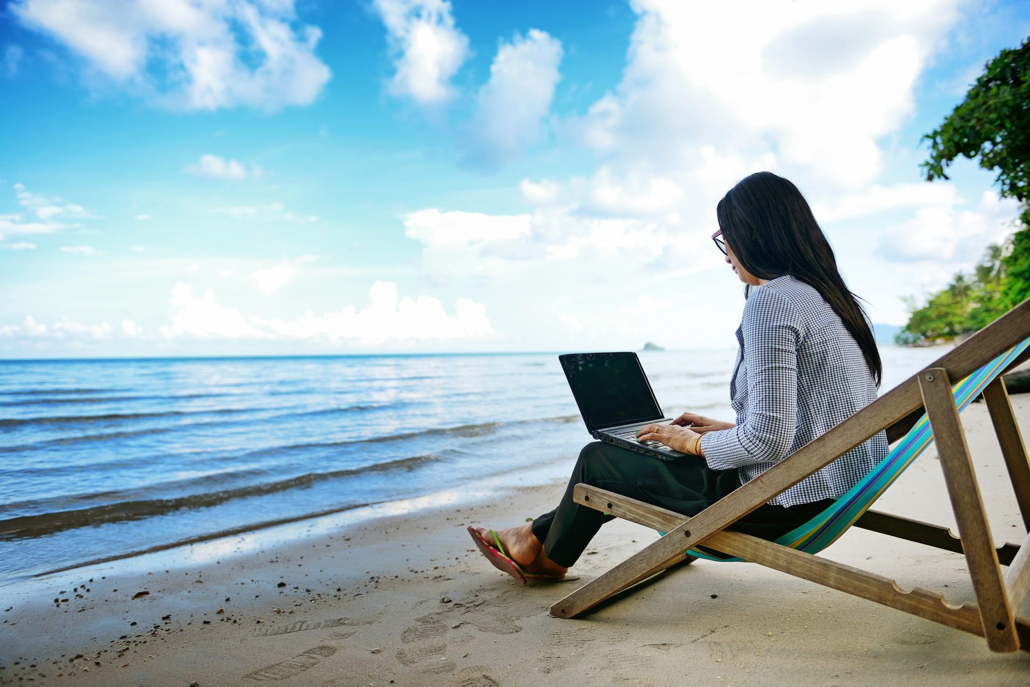 Девушка с ноутбуком на пляже